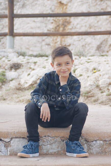 Portrait Of A Smiling Boy Sitting On A Step Malaga Andalucia Spain