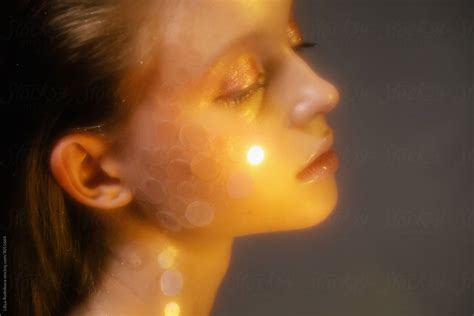 Young Woman With Glitter Makeup In Golden Light By Stocksy