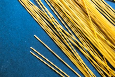 Premium Photo Wheat Pasta Close Up On A Blue Background With Copy Space