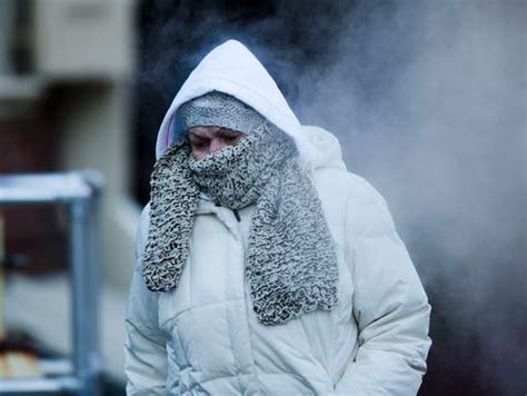 A Commuter Walks Along Market Street In Freezing Temperatures