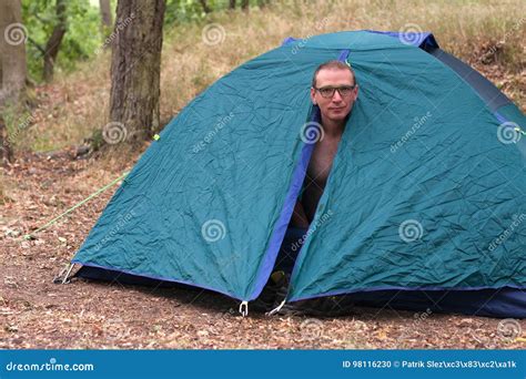 Topless Man Gets Up In The Morning In His Camping Tent Stock Photo