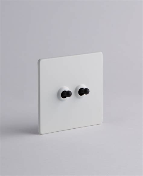 White Double Toggle Switch For Lights With Black Gold Or Silver Toggles