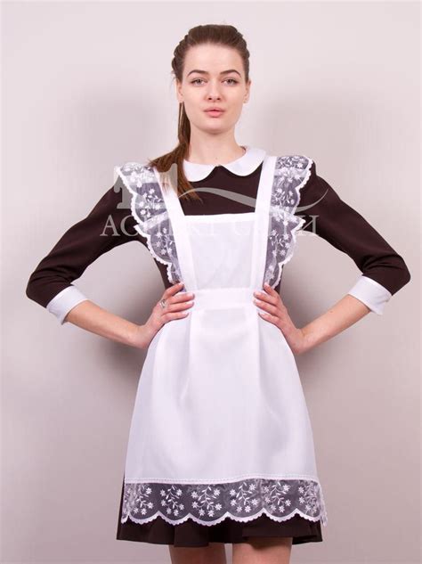 A Woman In An Apron Posing For The Camera With Her Hands On Her Hips