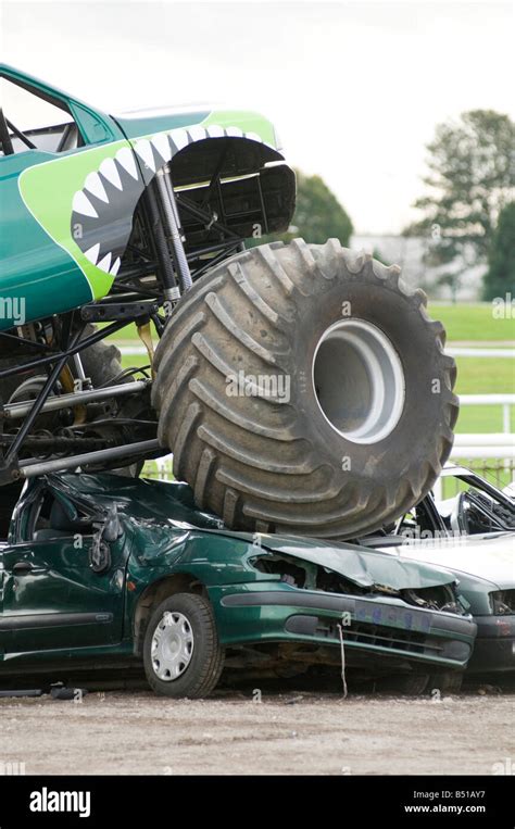 Monster Truck Crushing Junk Car Stock Photo Alamy