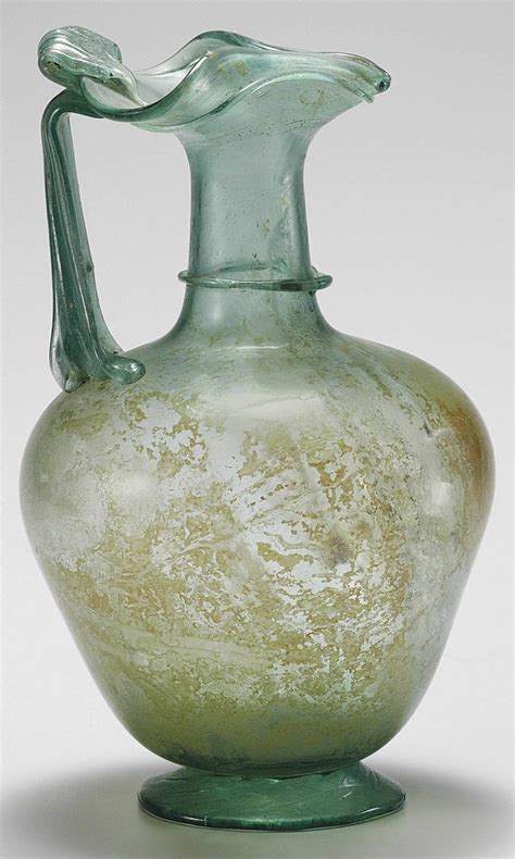 Roman Glass Jug Circa 3rd 4th Century A D Blue Green In Color Free Blown The Broad Ovoid Body