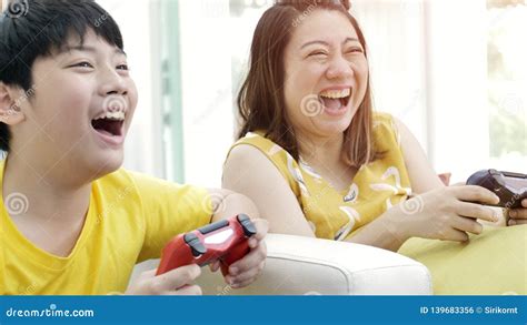 Asian Mother And Son Playing Video Game At Home Stock Photo Image Of