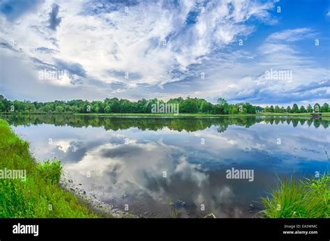 Sun Setting Over A Reflective Lake Stock Photo Alamy