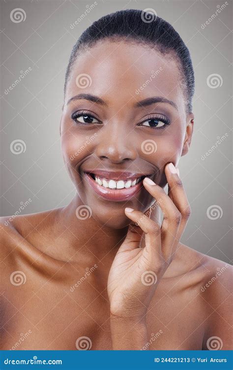 Beauty With A Smile Portrait Of A Beautiful African American Woman Touching Her Skin Stock
