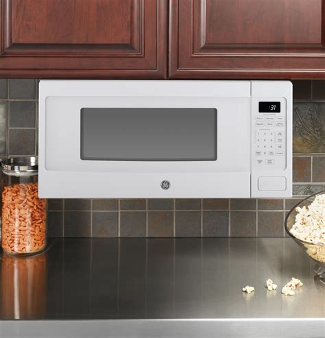 Ge Profile Series 11 Cu Ft Mid Size Microwave White On White