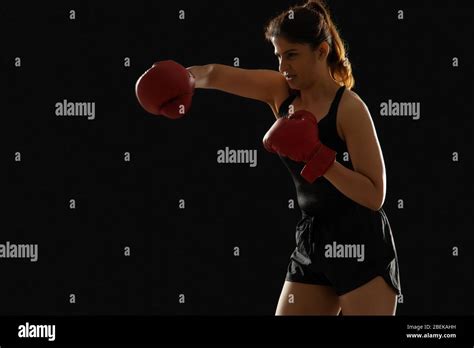 Woman Wearing Boxing Gloves Throwing A Punch In The Air Stock Photo Alamy