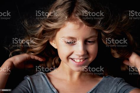 Kinky Girl With Long Hair In The Studio On A Black Background A Fairy