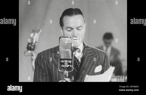 1940s Bob Hope Speaks Before Microphone Raises Arm To Introduce Next Star Stock Video Footage