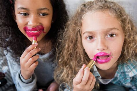Girls Applying Messy Lipstick Stock Photo Dissolve