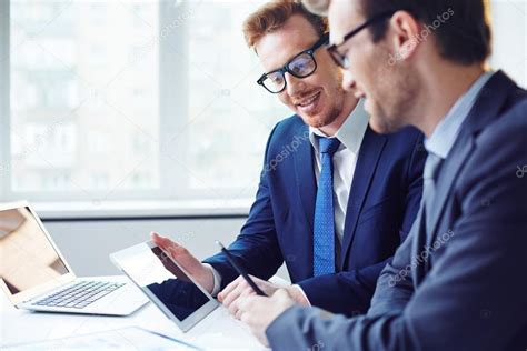 Businessmen Using Modern Gadgets At Meeting — Stock Photo © Pressmaster