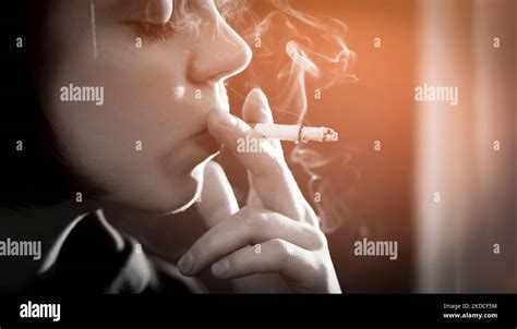 Girl Is Holding A Cigarette In Her Hand Smoking Closeup Stock Photo