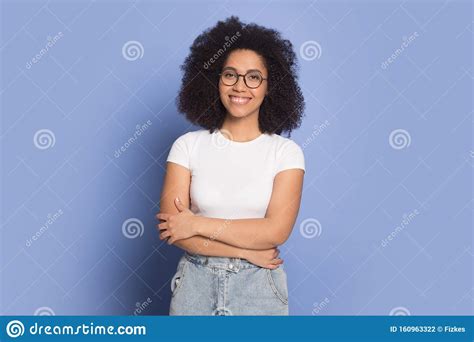 Smiling African American Girl In Glasses Posing In Studio Stock Photo
