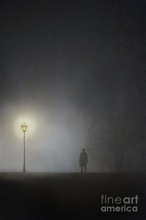 Sinister Man Standing Beneath A Streetlight In Winter Fog Photograph By