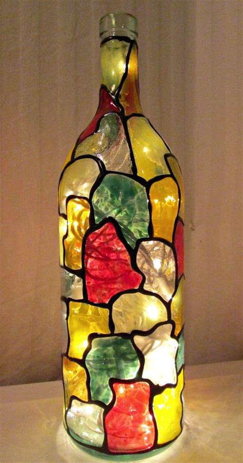 A Glass Bottle That Has Been Decorated With Multicolored Rocks On The
