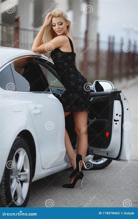 Portrait Of A Beautiful Blonde Girl Outdoors In Summer Near A Car Stock