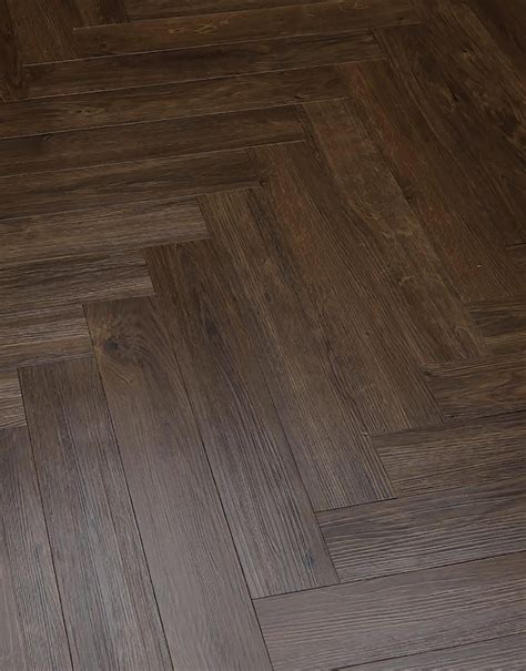 Coming in a lighter tone than many other herringbone floors, it offers a refreshing take on a timeless parquet style. Herringbone - Vintage Oak LVT Flooring | Direct Wood Flooring