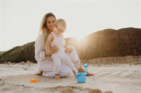 Happy Beautiful Mother And Son Playing In Sand Stock Image Image Of