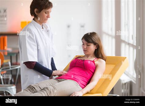 Doctor Examining The Abdomen Of A Female Patient By Palpation Stock