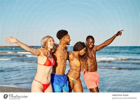 Diverse Friends Hugging And Walking Near Sea A Royalty Free Stock