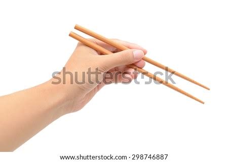 When you eat at the japanese restaurant near your home, you probably get a pair of disposable chopsticks that show the correct method of using chopsticks printed on the sleeve. Hand Holding Chopsticks Isolated On White Stock Photo 360587540 - Shutterstock