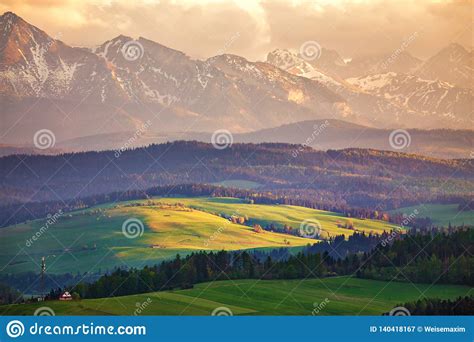 Snow Caped Mountains And Green Fields And Meadows Stock Image Image