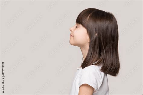 Profile Of Serene Little Girl Isolated On Grey Studio Background Stock