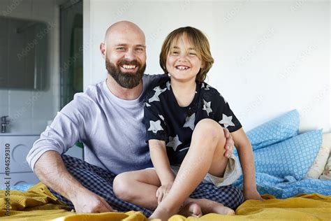Smiling Babe Sitting On Father S Lap In Bedroom Stock Photo Adobe Stock