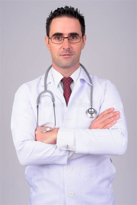 Portrait Of Handsome Man Doctor Against White Background Stock Photo