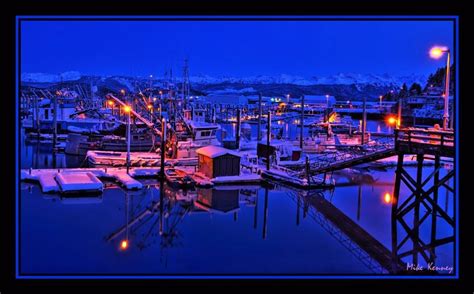 A Blanket Of Snow Covers The Boats And Dock On A Cold December Night In