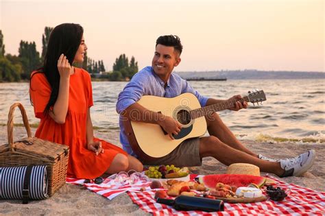 lovely couple having picnic near river at sunset stock image image of sand river 233689865
