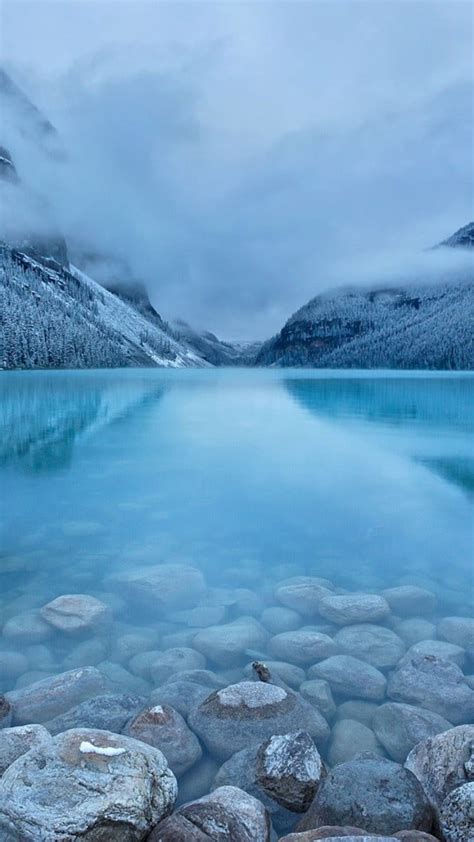 Landscape Photography Of Gray Stone In Body Of Water During Cloudy