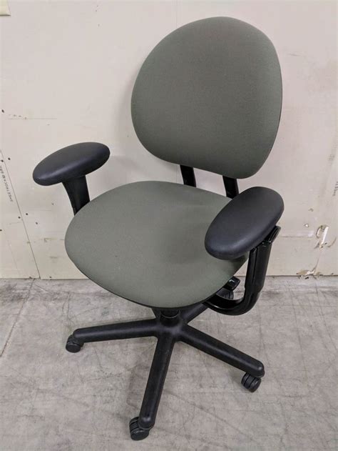 Office with table, chairs, green plants and digital devices. Steelcase Green Rolling Office Chairs | Madison Liquidators