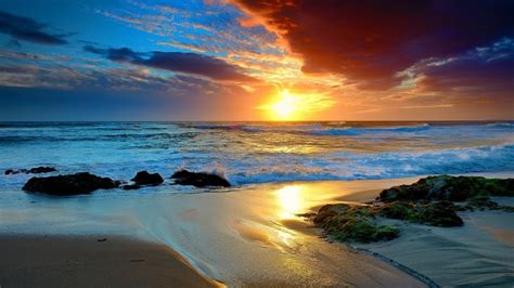 1920x1080 Oean Waves Sunset Sky Clouds Rocks Sea Beach Sand