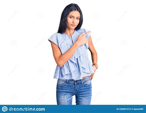 Young Beautiful Latin Girl Wearing Casual Clothes Pointing With Hand Finger To The Side Showing