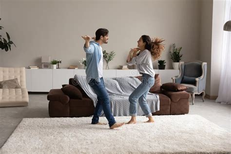 Carefree Active Couple Dancing In Living Room Full Length View Stock