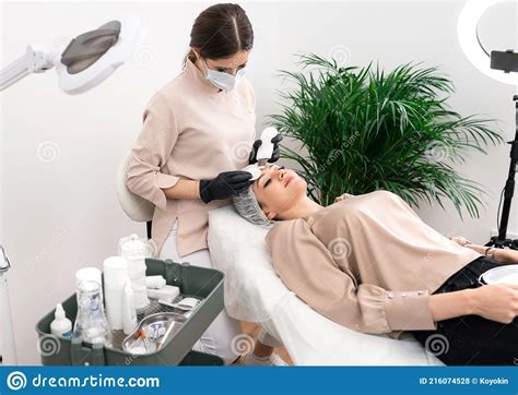 Doctor Cosmetologist Making Procedure Of Ultrasound Cleaning Of The