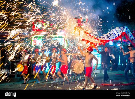 Chinese Entertainers Perform A Dragon Dance In Sparks Of Fireworks To