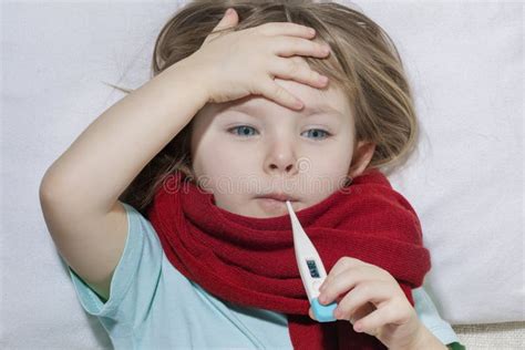 Sick Girl Lying In Bed With A Thermometer In Mouth Stock Image Image