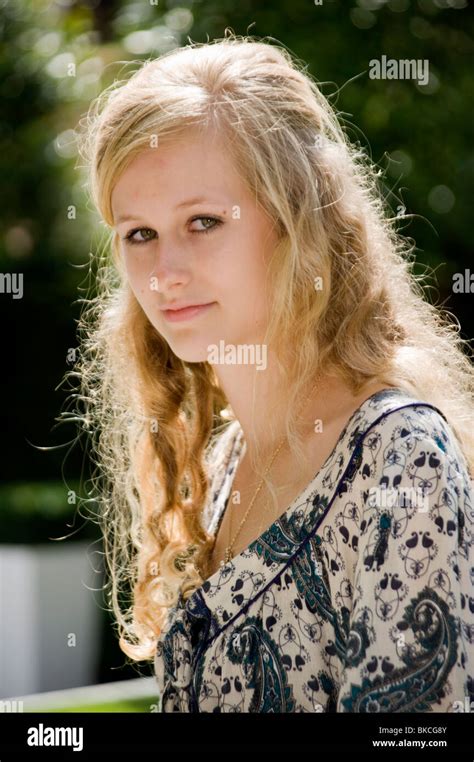 Portrait Of A Blonde Teenage Girl With Curly Hair And