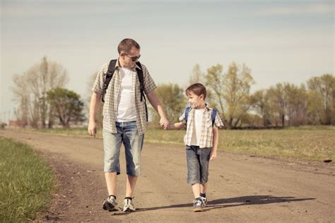 Father And Son Walking On The Road At The Day Time Stock Image Image