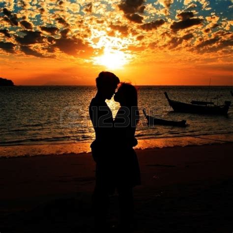 romantic silhouette of love couples on the beach