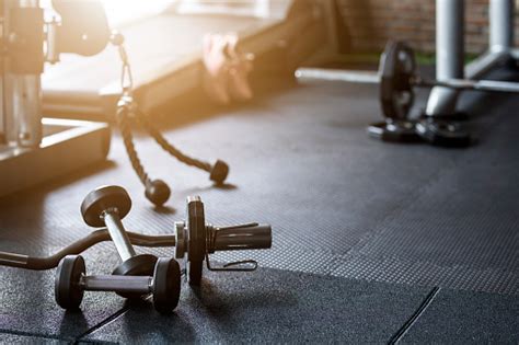 Gym Background Fitness Weight Equipment On Empty Dark Floor Stock Photo