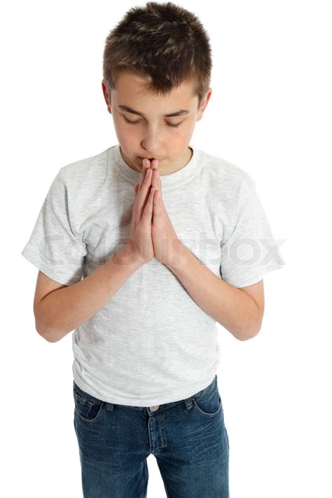 A Pre Teen Boy With Hands Together In Prayer Worship Devotion Or