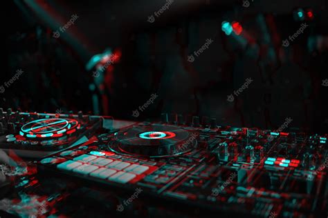 Premium Photo Dj Console For Mixing Music With Blurry People Dancing