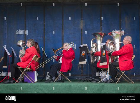 Musicians From The Phoenix Brass Band In Red Jackets Play On Stage On Their Converted