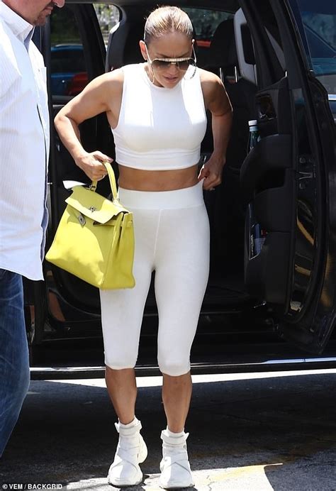jennifer lopez shows off her toned figure in all white workout outfit as she hits the gym
